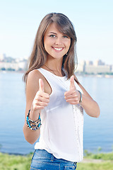 Image showing Gorgeous young woman showing thumbs up