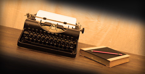 Image showing Vintage typewriter and old books