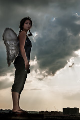 Image showing Attractive woman with angel wings on roof
