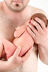Image showing hands of a father holding his newborn baby girl 