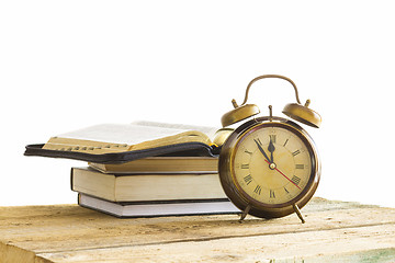 Image showing Bible with clock on wood