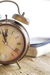 Image showing Clock and Bible on wood