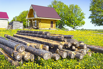 Image showing Wooden house in the meadow with dandelions. Russia