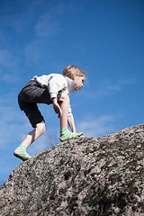 Image showing little girl climbing the rock