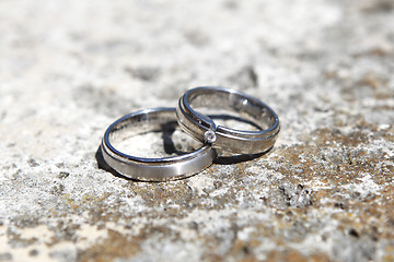 Image showing Wedding rings on a stone wall