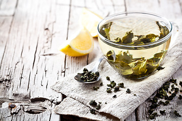 Image showing cup of green tea and lemon