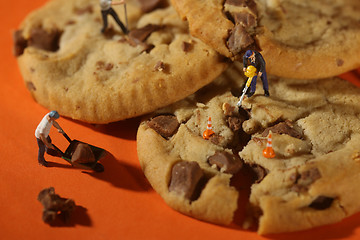 Image showing  Plastic People Working on Chocolate Chip Cookies