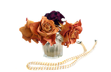 Image showing Composition of three dried roses and string of pearls