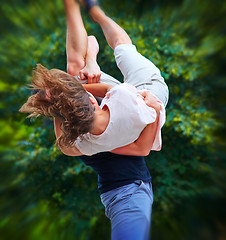 Image showing Man lifts up girl