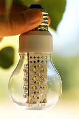 Image showing Light bulb held in palm