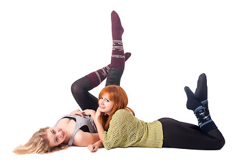 Image showing Two attractive girls lie and have fun