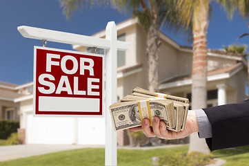 Image showing Buyer Handing Over Cash for House with For Sale Sign