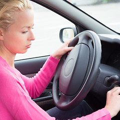 Image showing Female car driver starting the engine.