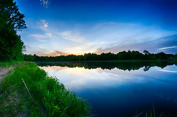 Image showing sun setting over a reflective lake