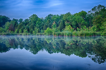 Image showing sun rising over a foggy lake early morning