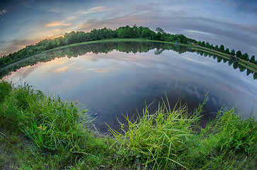 Image showing sun setting over a reflective lake