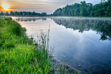 Image showing sun rising over a foggy lake early morning