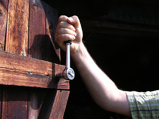 Image showing Cutout hand with ratch on wooden door