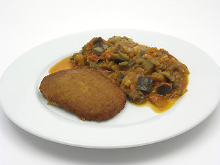 Image showing Breaded bean curd cutlet with fried vegetable on a white plate