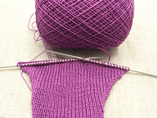 Image showing Pink colored knitting on a  beige background