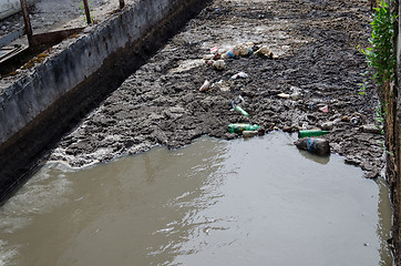 Image showing Urban sewage water and garbage flow course bar 