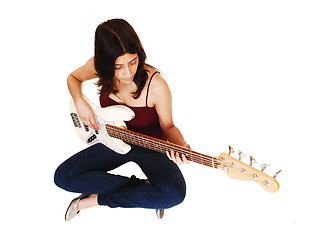 Image showing Sitting woman playing guitar.