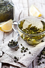 Image showing cup of green tea and lemon