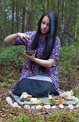 Image showing Girl witch conjures in the woods 