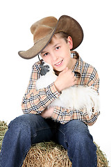 Image showing Farm boy holding a chicken