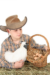 Image showing Farm boy with basket of eggs