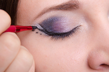 Image showing Makeup artist draws arrows on the eyelids model