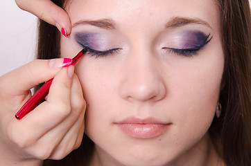 Image showing Bright makeup. Makeup artist brings eyelashes