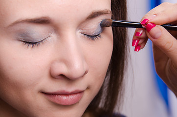 Image showing Makeup artist paint brush forever young girl