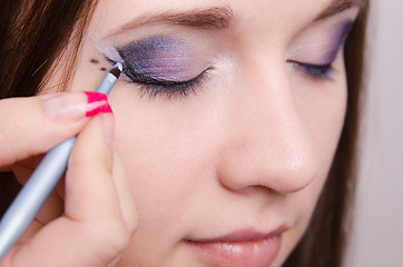 Image showing Close-up makeup application shooter