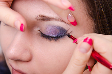 Image showing Bright makeup. Makeup artist starts causing arrows