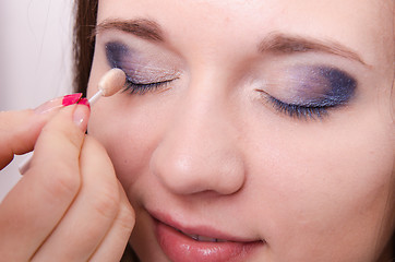 Image showing Makeup artist is shaded eyelids model