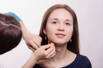 Image showing Beautiful model is applied concealer on neck