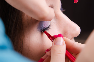 Image showing Makeup artist brings pencil eyelashes model