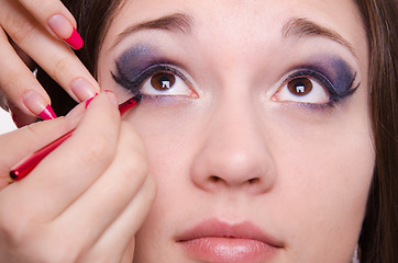 Image showing Bright makeup. Makeup artist brings arrows