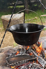 Image showing big metal pot on camp fire