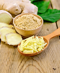 Image showing Ginger powder and grated on board with root and leaves