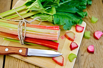 Image showing Rhubarb cut with a leaf on board