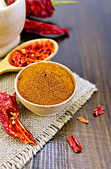 Image showing Pepper red in wooden bowl with burlap on board