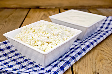 Image showing Curd and sour cream in bowls on board with napkin