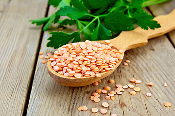 Image showing Lentils red in a wooden spoon on board