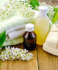 Image showing Oil with lotion and bird cherry on board