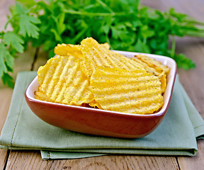 Image showing Chips grooved in bowl on board