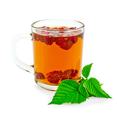 Image showing Tea with raspberry and green leaf in glass mug