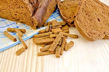 Image showing Rye homemade bread on board with crackers