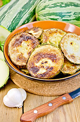 Image showing Zucchini fried with a knife on board